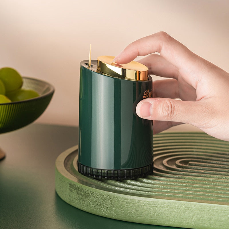 Tandstikholder med trykfunktion til bord